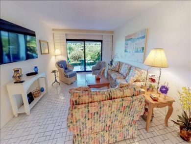 Just Steps to the Sandy Beach from this Two Bedroom Condo